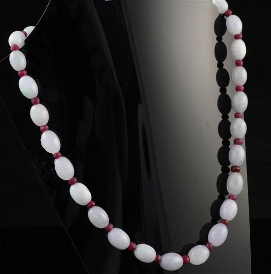 A single strand graduated oval jadeite bead necklace, 18in.